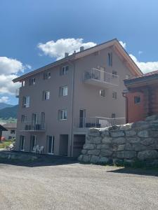 duży biały budynek z kamienną ścianą w obiekcie Haus Baracca w mieście Vella