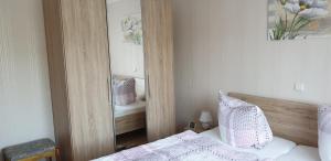 a mirror in a bedroom with a bed and a mirror at Haus Anna in Kelberg