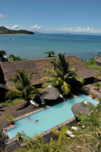 an aerial view of a resort with a swimming pool and the ocean at L'heure Bleue in Ambatoloaka