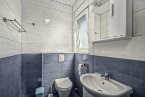 a small bathroom with a sink and a toilet at Apartmani Rebecca in Vir