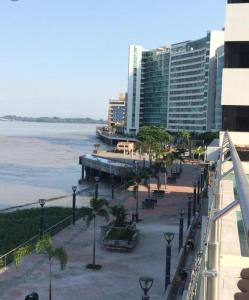 a view of a beach with a building and the ocean at LUXURY APARTMENT PUERTO SANTA ANA GUAYAQUIL in Guayaquil +35 photos
