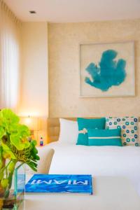 a bedroom with a bed and a vase of flowers at The Marlin Hotel in Miami Beach