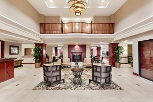 a large lobby with a fireplace and furniture at Wingate by Wyndham Columbia/Lexington in Lexington