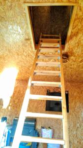a row of stairs in a room with a ceiling at Domek Łukaszówka in Jonkowo