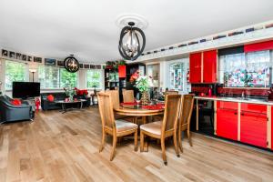 a kitchen with red cabinets and a table and chairs at Diana's Luxury Bed and Breakfast in Vancouver