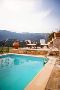 a swimming pool with a view of the mountains at Stone Built Villa Galatia, Poolside & Perfect View in Karés
