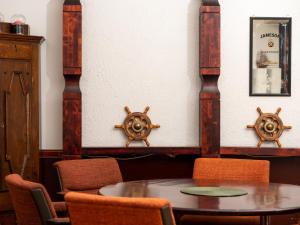a dining room with a table and two ships on the wall at Hotel Jahtihovi in Kuopio
