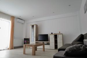 a living room with a couch and a coffee table at Apartament Deea in Mamaia Nord