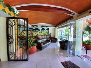 a living room with a wrought iron gate at Hotel Suites Elia Noemi in Mérida