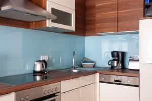 a kitchen with a sink and a counter top at Center Rev Apartment in Győr