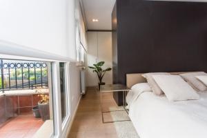 a bedroom with a large white bed and a window at Orio playa lucirá in Orio +34 photos