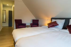 Voodi või voodid majutusasutuse Hotel Huron toas