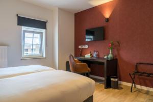 Voodi või voodid majutusasutuse Hotel Huron toas