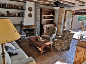 a living room with a couch and two chairs and a table at Cal Nicet in Perafita