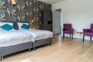 Voodi või voodid majutusasutuse Hotel Huron toas