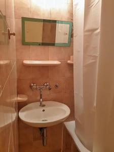 a bathroom with a sink and a mirror at Old Town Point in Budva