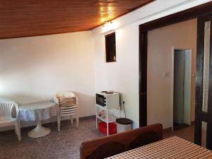 a room with a bed and a table and a chair at Kuca Pavle Trsteno in Budva