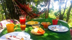 a table with plates of food and drinks on it at Hostel do Morro in Florianópolis
