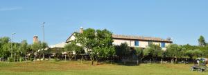 a house with a bunch of trees in front of it at Bed&Breakfast Monte Rosso in Poreč