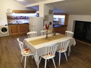 a kitchen with a table with chairs and a refrigerator at Villa Meri in Rijeka