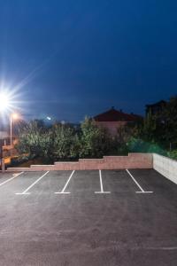 a parking lot at night with the lights on at Apartments Bašić in Visoko