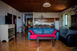 a living room with a blue couch and a kitchen at Apartments Ozren-amazing sea view in Omiš
