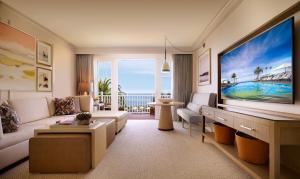 a living room with a large screen tv and a living room at Montage Laguna Beach in Laguna Beach