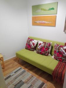 
a red couch sitting in a living room next to a wall at Era Uma Vez Apartment in Vila Real
