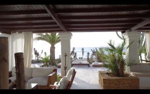 a patio with white furniture and a view of the ocean at Villa Playa Mojacar in Mojácar