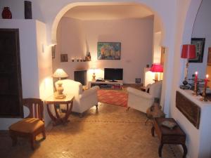 a living room with white furniture and a tv at Darmimouna in Asilah
