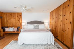 a bedroom with a large bed with wooden walls at Hummingbird Estate in Central Point