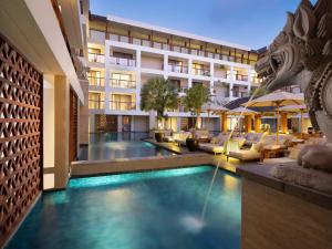 
a hotel room with a large swimming pool at The Bandha Hotel & Suites in Legian

