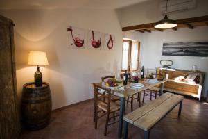 a dining room with a table and chairs and a barrel at VINO SUITE in San Quirico dʼOrcia