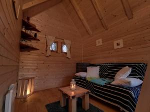 a living room with a couch in a log cabin at Riverland in Gornji Zvečaj