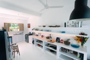 a kitchen with white shelves and a counter at Casa Blava in Las Galeras