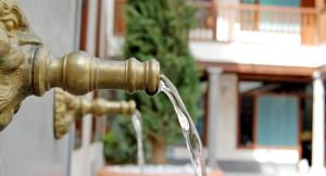 un grifo de agua de latón con agua saliendo de él en ISA Granada, en Granada