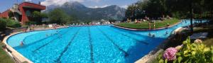 a large swimming pool with people in the water at Bellagio Dream in Valbrona