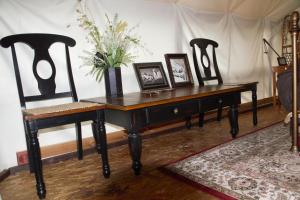 a desk with two chairs and a table with pictures on it at Sven's Basecamp Hostel in Fairbanks