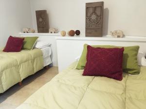 a bedroom with two beds and a shelf with stuffed animals at Como en casa... en gran Mendoza in Mendoza