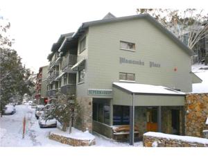 a building on a street with snow on the ground at Mowamba F2 in Thredbo