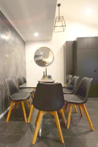 a dining room with chairs and a table and a mirror at Mowamba F2 in Thredbo +16 photos