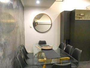 a dining room with a glass table and chairs at Mowamba F2 in Thredbo