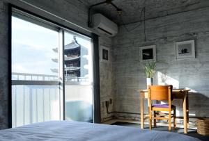 a bedroom with a bed and a desk and a window at Rc Hotel Kyoto Yasaka in Kyoto