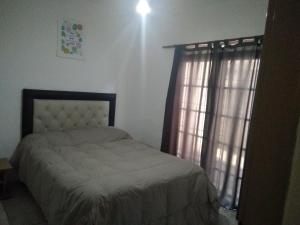 a bedroom with a bed and a window at Helenita in Villa Mercedes
