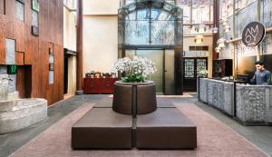 a lobby with a table with flowers in it at AMOY by Far East Hospitality in Singapore