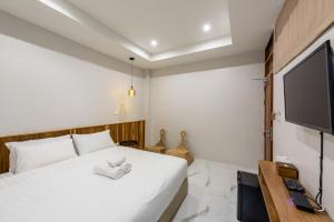 Säng eller sängar i ett rum på U Chiangkhan