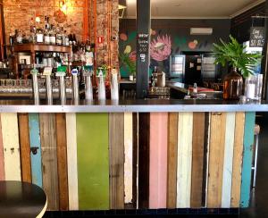 a bar with a wooden fence behind it at The Franklin Boutique Hotel in Adelaide