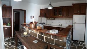 a kitchen with a table and a white refrigerator at Peggy's house in Monastiraki
