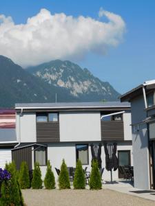 a building with chairs and a mountain in the background at Mountain Vista Suites in Zărneşti