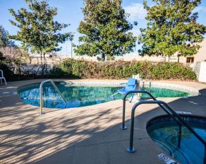 a swimming pool with a slide in front of some trees at Comfort Inn Redding Near I-5 in Redding